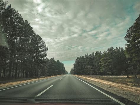 Beautiful Clean Smooth Road Cloudy Sky And Forest Around Stock Photo