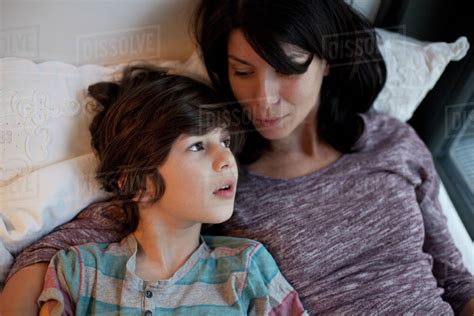 Mother And Son Lying On Bed Stock Photo Dissolve