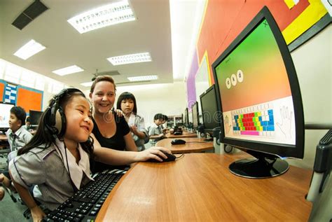 Asian Elementary Child Learning To Use Computer In Classroom Editorial