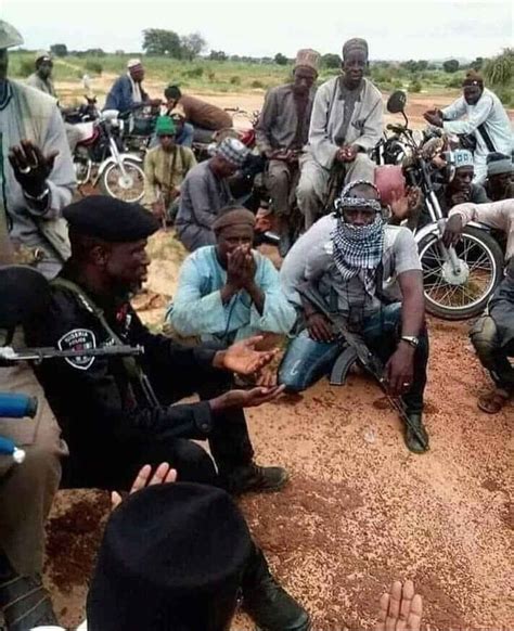 photo nigerian policeman and suspected armed bandits spotted praying together in the north