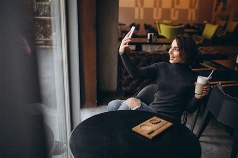 Premium Photo Woman In Cafe Doing Selfie And Drinking Coffee