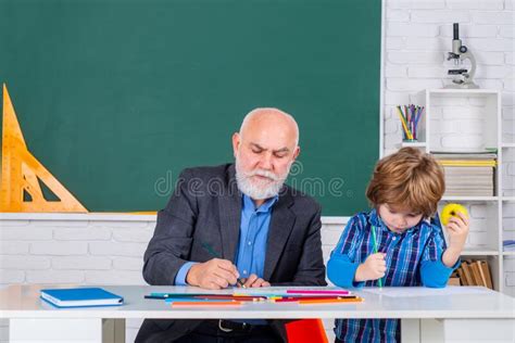 A Grandfather And A Son Are Learning In Class Student And Tutoring