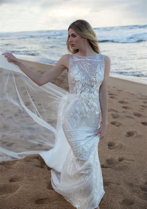 A magnificent display of embroidery throughout, a very enticing fit that flaunts all of your features in a sophisticated and beautiful manner, and a gorgeous tussled train that is incredibly trendy and sophisticated. Wedding Dresses for the Beach Bride! - Modern Wedding