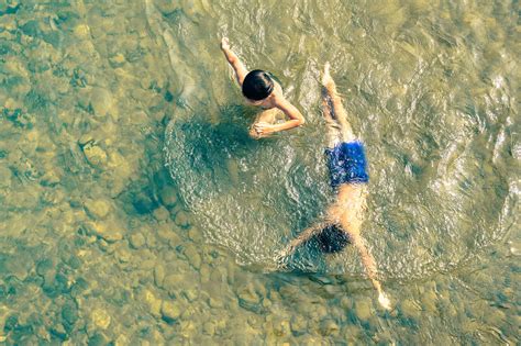 Playful Children Swimming In Nam Song River In Vang Vieng Shutterstock