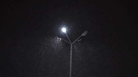Snow Falling By Night Near A Street Lamp Stock Video Footage Storyblocks