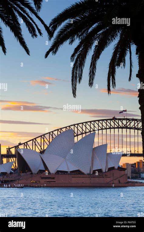 The Illuminated Sydney Opera House With Harbor Bridge At Sunset Hi Res