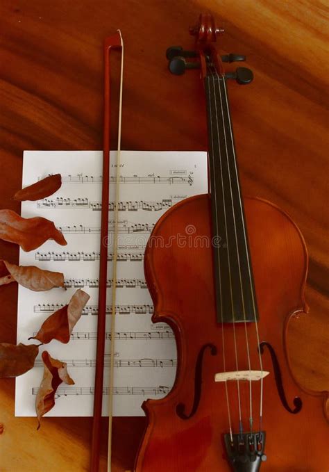 Sheet Music And Violin On Wooden Table Top View Classical Musical