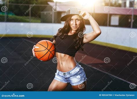 Beautiful Brunette Woman Playing Basketball On Court Outdoor Stock