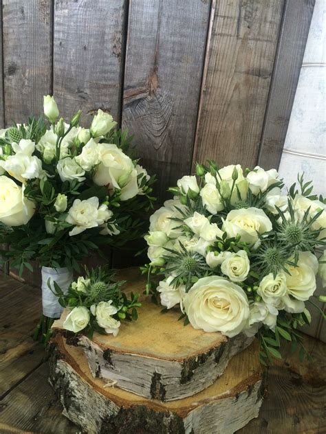 These stunning artificial wedding bouquets and accessories are made with ivory roses with added thistle and lavender. White, creams & green thistle & rose bridal bouquet | Rose bridal bouquet, Bridal bouquet ...