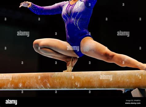 female gymnast athlete balancing on balance beam gymnastics olympic sports included in summer