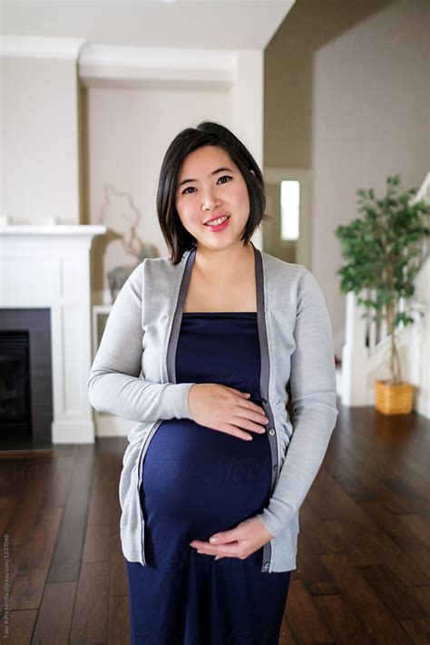 Pregnant Asian Woman At Home By Take A Pix Media