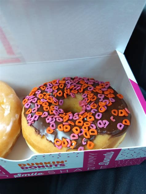 Two Donuts In A Box With Sprinkles On Them