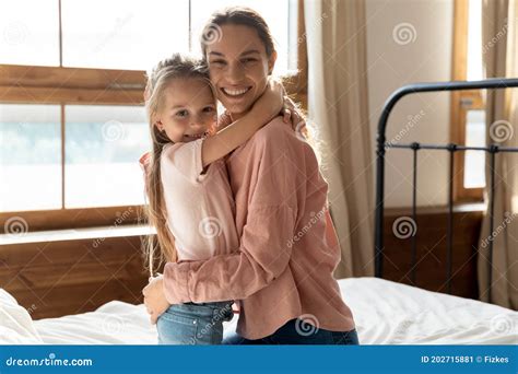 Mother And Little Daughter Hugging In Bedroom Stock Image Image Of