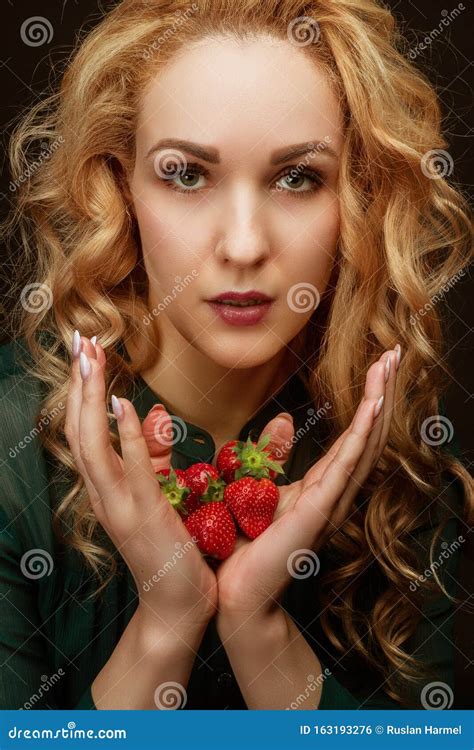 Beautiful Resilient Young Girl Holding A Strawberry Portrait In The