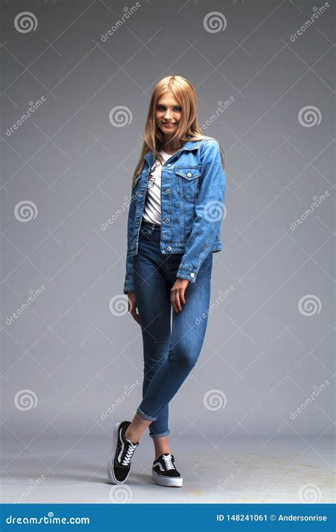 Beautiful Blonde Woman Dressed In A Denim Jacket And Blue Jeans Stock Image Image Of Clothes