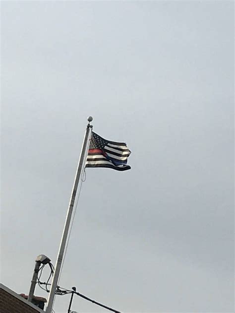 When deputies hoisted the flag outside government. Black and white American flag with one stripe half red and ...
