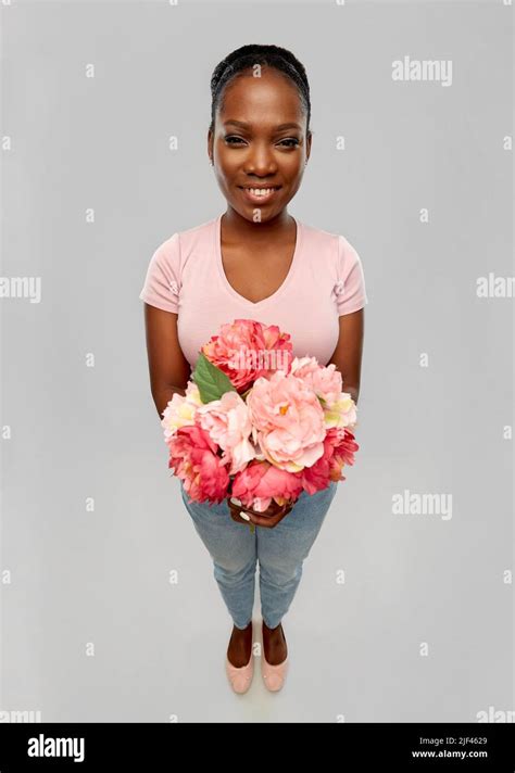 Happy African American Woman With Bunch Of Flowers Stock Photo Alamy