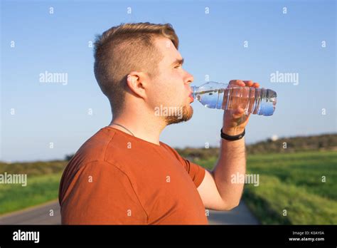 Caucasian Man Drinking Water With His Eyes Closed After Exercises Stock