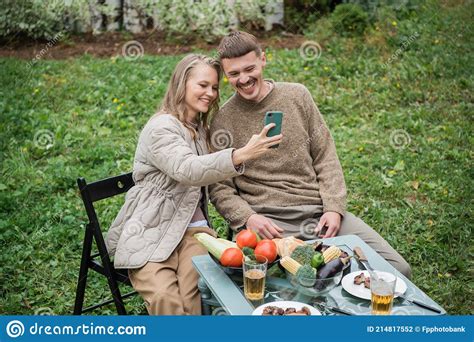 Newlyweds Fool Around At A Picnic In The Backyard Take A Selfie On