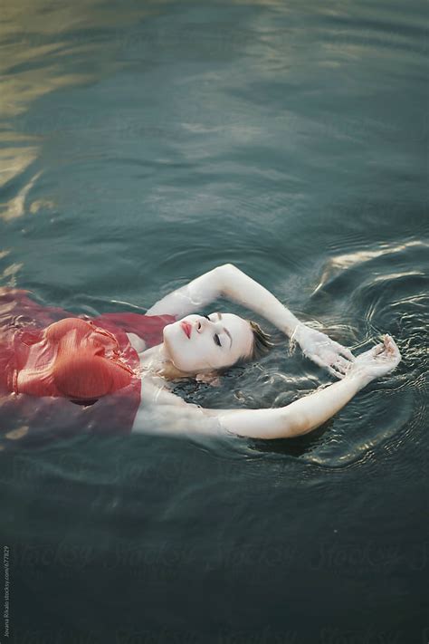 Beautiful Young Woman Floating On Water By Stocksy Contributor