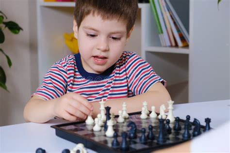 A Preschool Boy Plays Chess Board Games For Children Stock Image