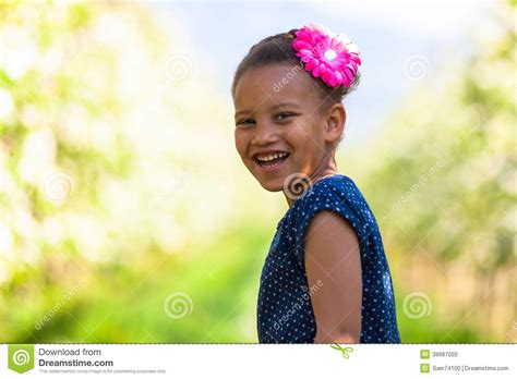 Outdoor Portrait Of A Cute Young Black Girl Smiling