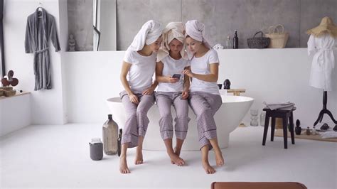 Three Positive Girlfriends In The Same Pajamas And Towels On Heads