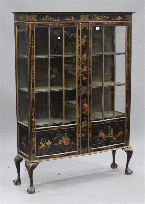 An Early 20th Century Black Chinoiserie Display Cabinet Decorated With