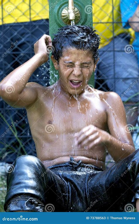 A Wrestler Cools Off Under The Water Fountains After Competing In Hot