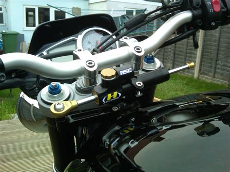 A steering damper, or steering stabiliser is a damping device designed to inhibit an undesirable, uncontrolled movement or oscillation of a vehicle steering mechanism, a phenomenon known in motorcycling as wobble. Steering Damper | 675.cc • Triumph 675 Forum