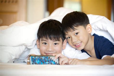 Asian Preschool Boys Playing On Smartphone Together Stock Photo Image