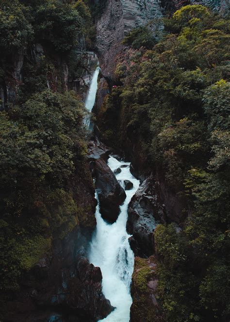 An Aerial View Of A Waterfall In The Middle Of Some Trees And Rocks