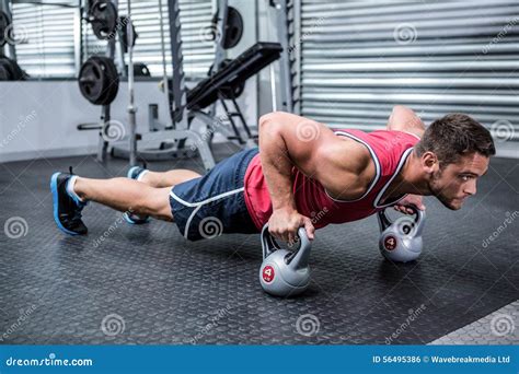 Muscular Man Doing Push Ups With Kettlebells Stock Photo Image Of
