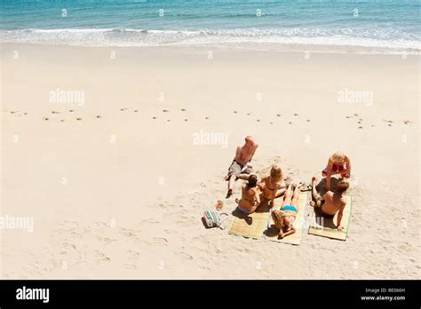 Group Of People Sunbathing On Beach Stock Photo Alamy