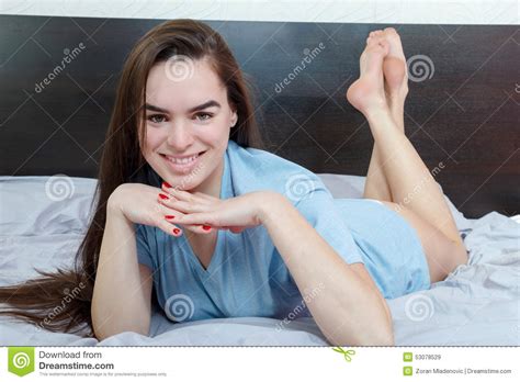 Girl On Bed Seducing Man While Looking At Camera Stock