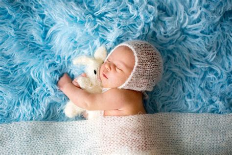 Little Cute Newborn Baby Boy Sleeping Wrapped In White Wrap Stock