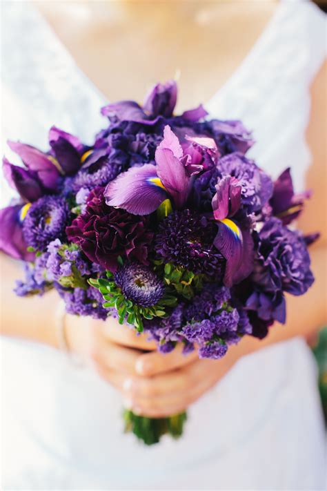 purple bridal bouquet with iris aster carnations and statice photograph by katy weaver