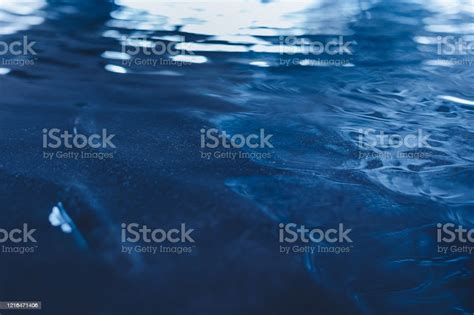 Dark Blue Colored Calm Wavy Water Surface Texture Stock Photo