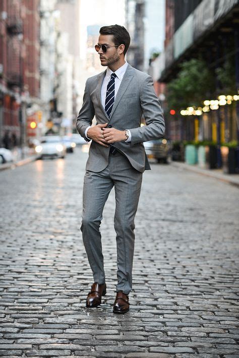 Charcoal thrives in cooler weather and formal, serious. Picture Of a grey suit, a striped tie and brown leather shoes for an elegant look