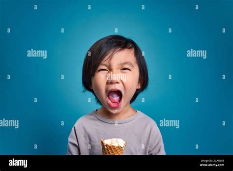 Excited Asian Little Kid Screaming Or Shouting Empty Space In Studio