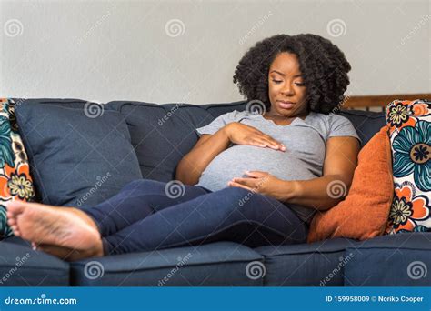 African American Pregnant Woman Sitting On A Sofa Stock Image Image