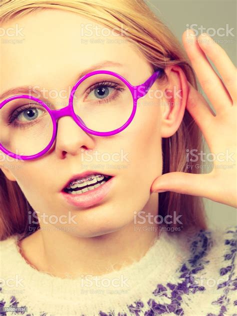 Woman Listening Carefully With Hand Close To Ear Stock Photo Download