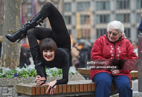 Contortionist Alina Ruppel Shows Off Her Skills Beside A Member Of