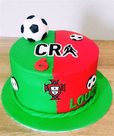 A Cake Decorated With Soccer Balls And The Word Cra On Its Side