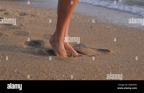 Close Up Woman Feet Walking Barefoot On Beach At Sunset Leaving Footprints In Stock Video
