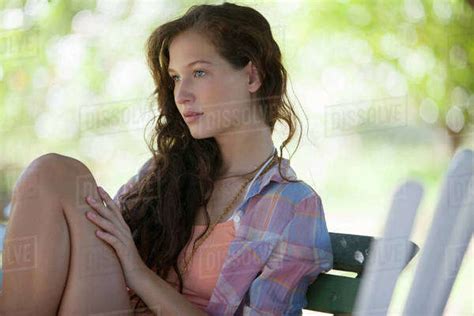Woman Sitting On Park Bench Stock Photo Dissolve