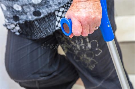 Hand Of An Elderly Disabled Woman Holding A Crutch Stock Photo Image