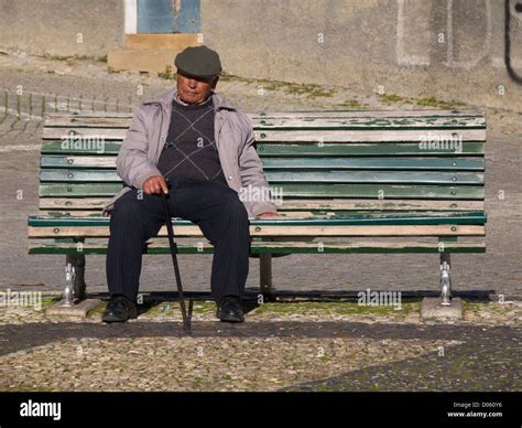 Lone Old Man Sitting On A Park Bench Stock Photo Alamy
