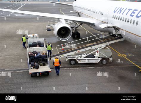 Baggage Handlers Loading United Airlines Boeing 757 At Belfast Stock