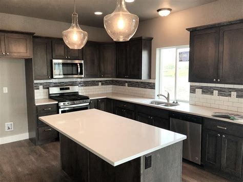 Countertop colors that complement gray cabinets. Check out our new spec house! Gray stained cabinets with ...